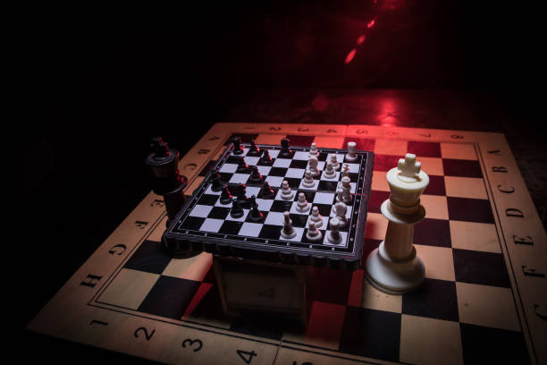 istock Chess figures on a dark background with smoke and fog. Selective focus 1202153960