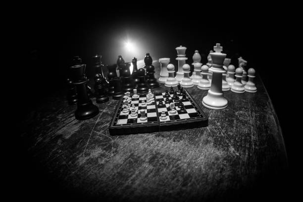 istock Chess figures on a dark background with smoke and fog. Selective focus 1202153963