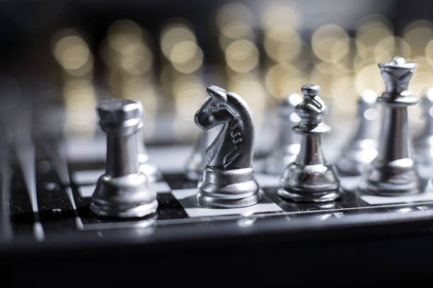 istock Chess figures on a dark background with smoke and fog. Selective focus 1202154130