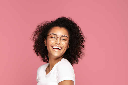 Happy african american student woman smiling. Beautiful female portrait. Young emotional afro woman. The human emotions, facial expression concept.