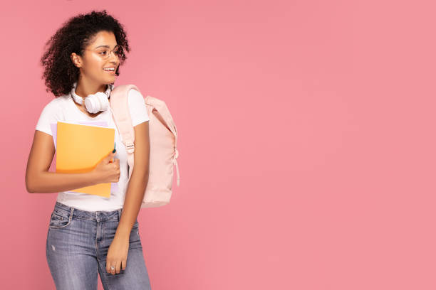 istock Happy student girl with backpack and notebooks. 1202157559