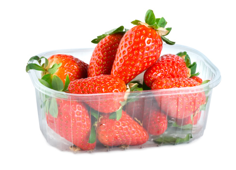 Strawberries in plastic container isolated on a white background