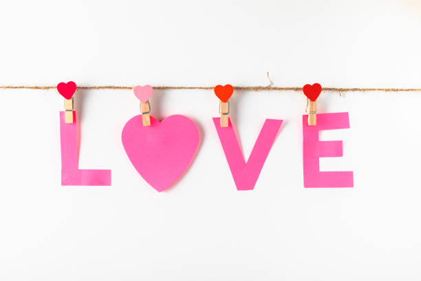 istock Paper love word on clothesline isolated on white background. 1202160841