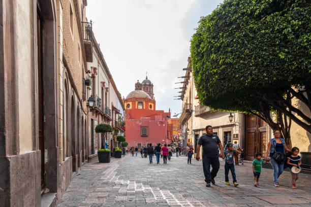 Santiago de Queretaro Santiago de Queretaro, Queretaro, Mexico - November 24, 2019: View down 5 de Mayo street, with people enjoying the day, towards Templo de San Francisco queretaro city stock pictures, royalty-free photos & images