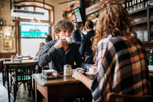 istock Couple drinking coffee in cafeteria 1202167377