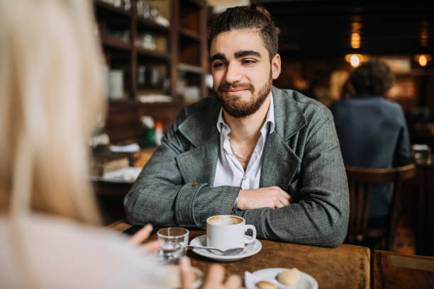 istock Couple drinking coffee in cafeteria 1202168356