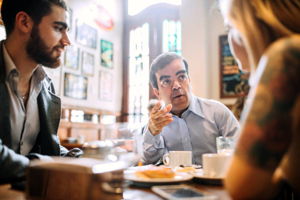 Mid adult man with dwarfism on business meeting with colleagues Mid adult man with dwarfism on business meeting with colleagues dwarf stock pictures, royalty-free photos & images