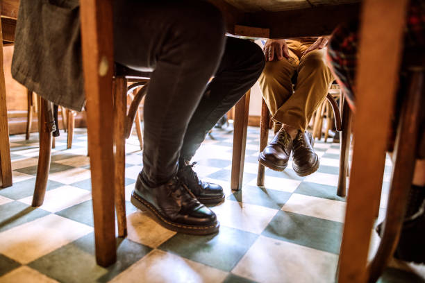 istock Man with dwarfism on coffee break in coffee shop with friends 1202169734