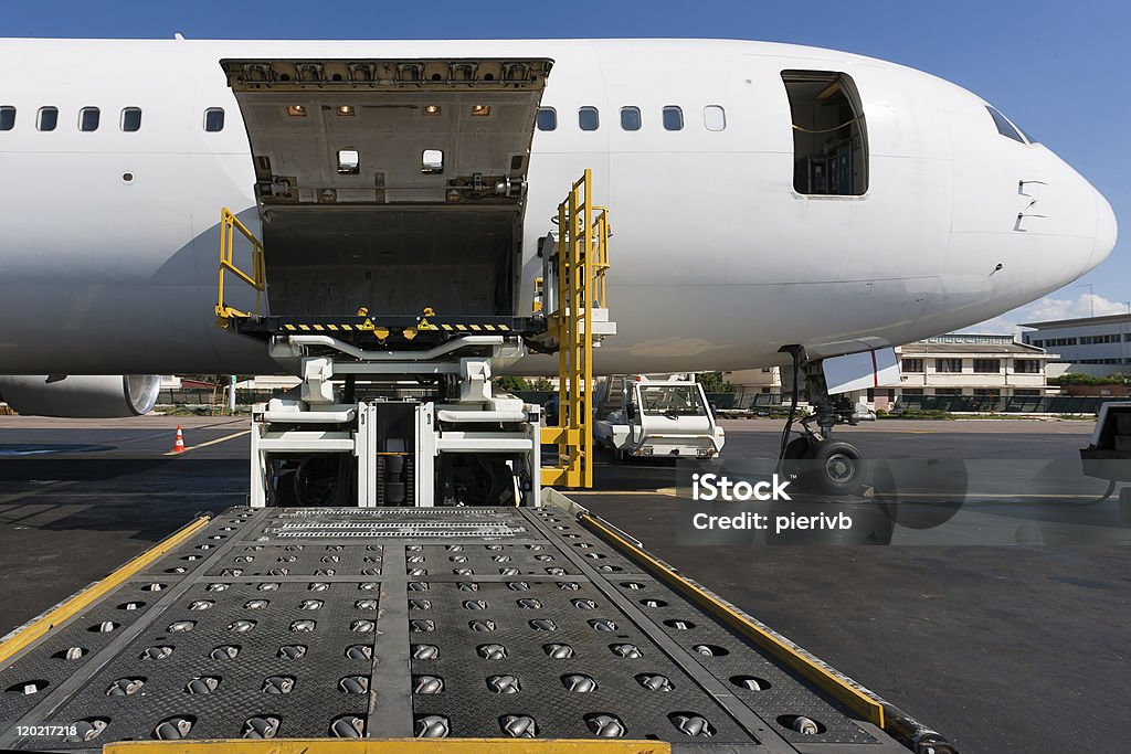Side cargo hatch of plane open to receive cargo Loading platform of air freight to the aircraft Airplane Stock Photo