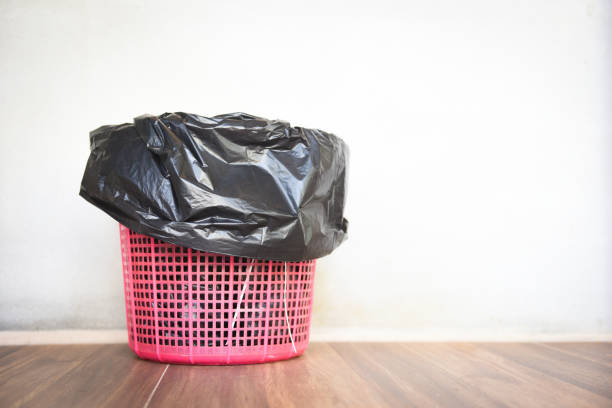 istock Waste bin , garbage waste and bag plastic black - recycle bin on wall background 1202173168