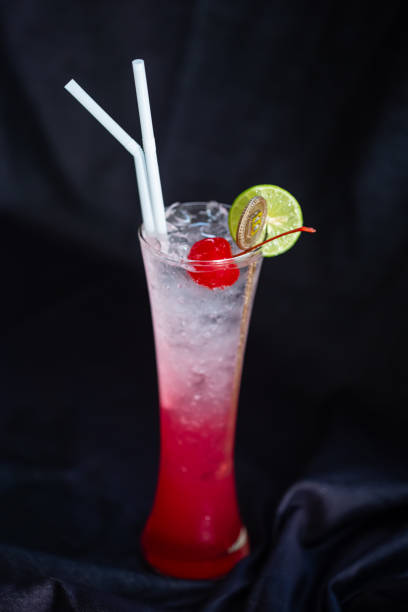 Cosmopolitan cocktail with lemon twist cutout.On the black cloth as the backdrop