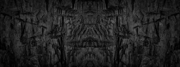 istock Black abstract grunge background. Burnt wooden surface with marks and nicks from an ax. 1202175256