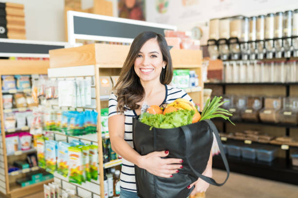 istock Smiling Female Standing In Supermarket 1202180101