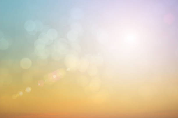 istock Natural background blurring warm colors and bright sun light. Bokeh or Christmas background Green Energy at sky sunny color orange light patterns plain abstract flare evening clouds blur. 1202180385