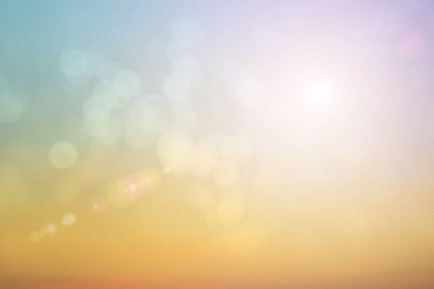 Natural background blurring warm colors and bright sun light. Bokeh or Christmas background Green Energy at sky sunny color orange light patterns plain abstract flare evening clouds blur. Natural background blurring warm colors and bright sun light. Bokeh or Christmas background Green Energy at sky sunny color orange light patterns plain abstract flare evening clouds blur. unmanned spacecraft stock pictures, royalty-free photos & images