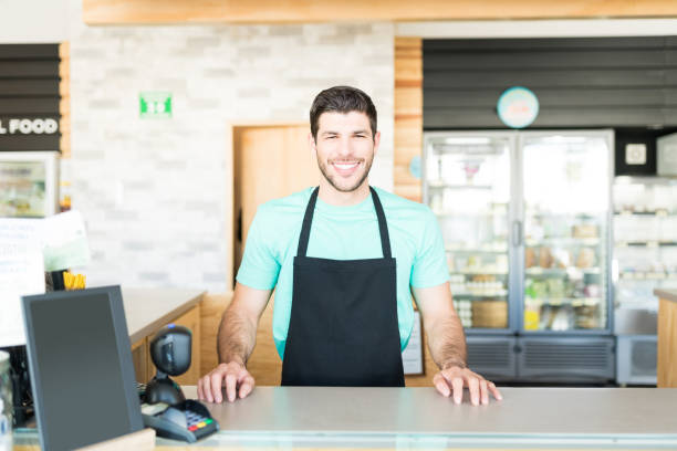 istock Confident Latin Owner In Supermarket 1202180406
