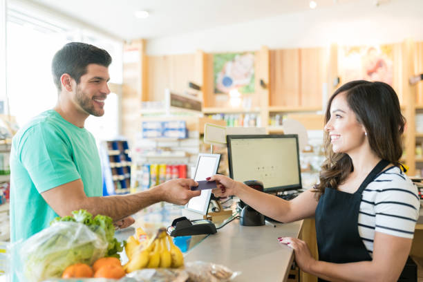 istock Man Making Payment Through Credit Card In Supermarket 1202180941
