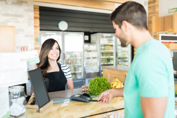 istock Man Making Payment Through Credit Card In Supermarket 1202180964