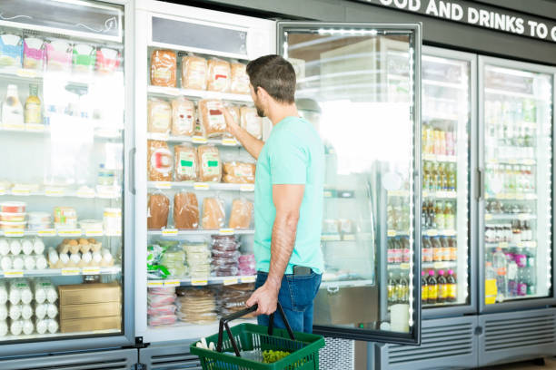 istock Male Customer With Basket In Grocery Store 1202180982