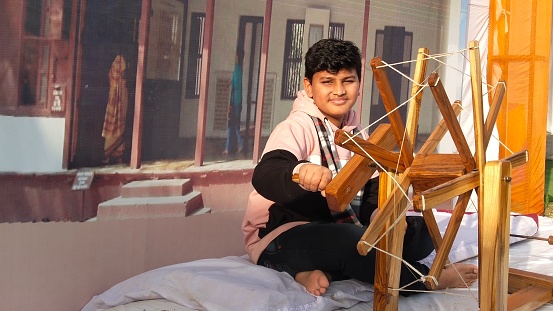 This boy in India is winding yarn on an antique yarn winder.  This nostalgic tool gives him hands-on experience seeing how such simple tasks were done years ago.