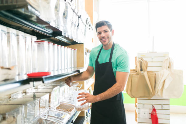 istock Young man working at a supermarket 1202182102