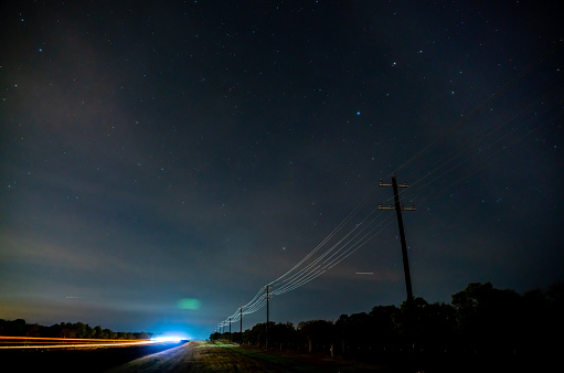 Wide Angle View of Hill Country Road At Night With Many Stars in the Sky
