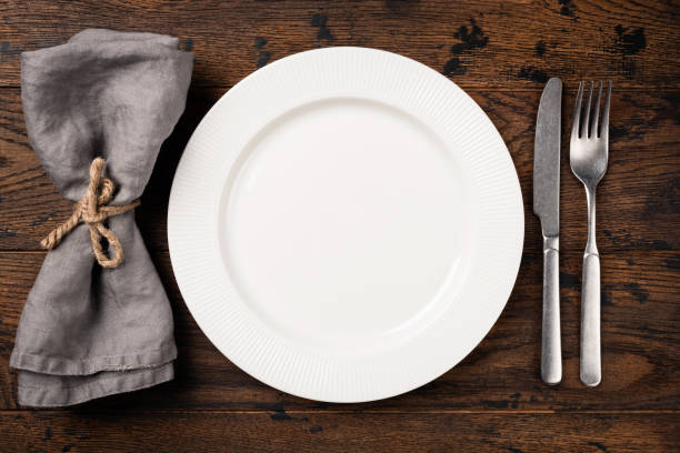白い白いプレート、カトラリー、テーブルナプキンを備えたテーブルセッティング - spoon fork table knife place setting ストックフォトと画像