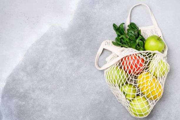 istock Mesh Shopping Bag With Fruits Greens 1202186052