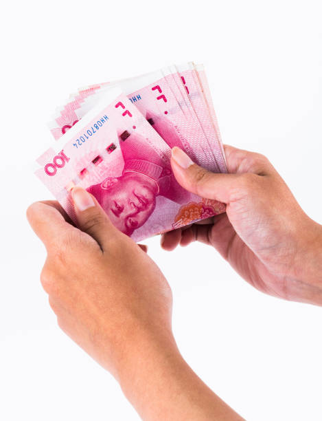 istock asian hand hold Chinese Rmb banknote money 1202192669