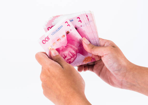 istock asian hand hold Chinese Rmb banknote money 1202192823