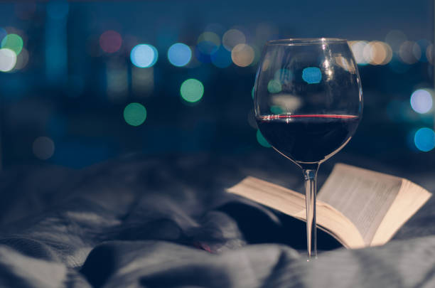 istock A glass of Red wine put on bed with book. 1202193968