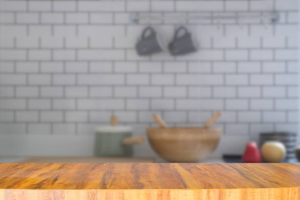 istock Empty long modern wooden counter on blurred kitchen room background 1202195856