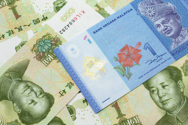istock A Malaysian ringgit on a background of Chinese one yuan bills 1202197846