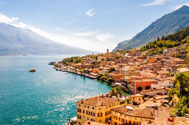 Photo of Limone Sul Garda cityscape on the shore of Garda lake surrounded by scenic Northern Italian nature. Amazing Italian cities of Lombardy