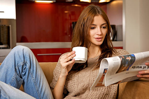 istock woman drinking coffee and reading news 120220448