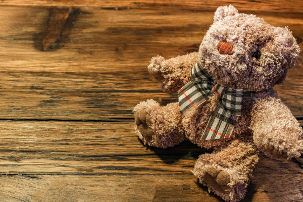 istock Brown teddy bear on the wood table 1202209287