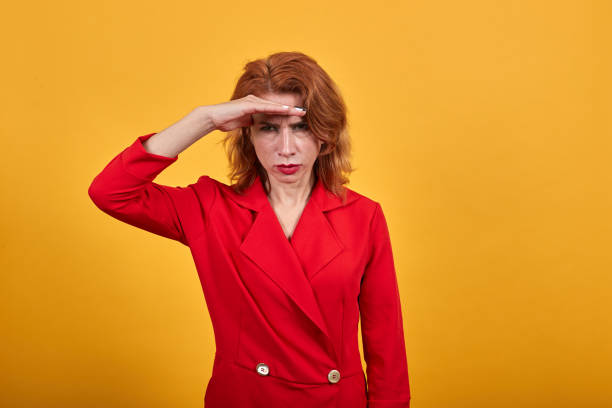 istock Serious young woman keeping hands on forehead, looking into distance 1202210203