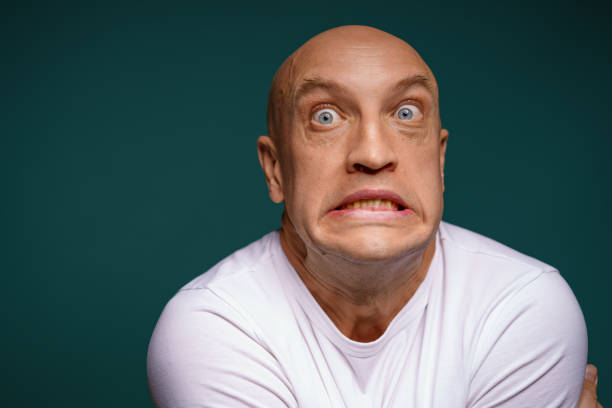 bald man with facial expressions on a blue background