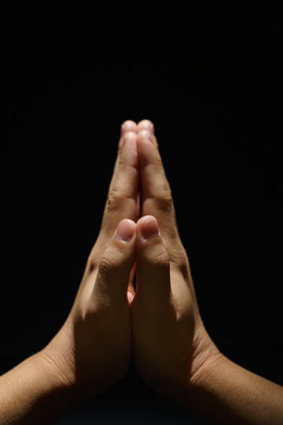 istock Praying boys hands in the dark background 1202211772
