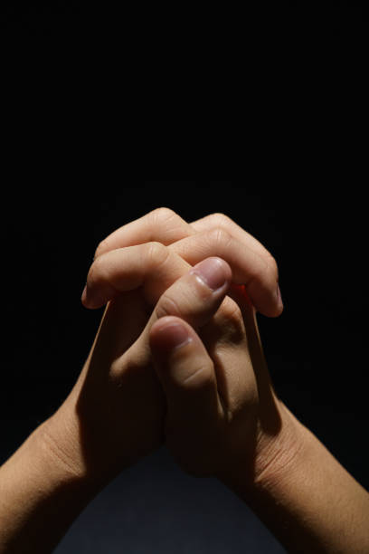 istock Praying boys hands in the dark background 1202211798