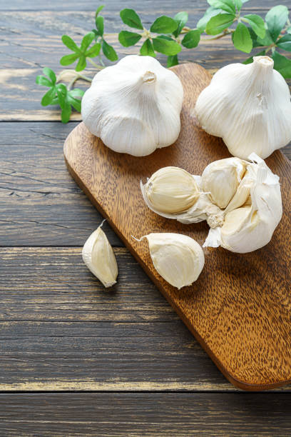 istock Garlic on wooden background 1202211907