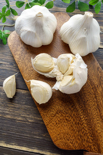istock Garlic on wooden background 1202211936