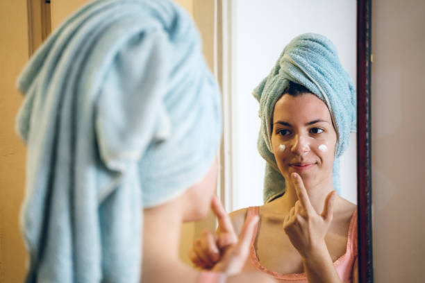 istock Beauty applying moisturizer on her Face 1202212857