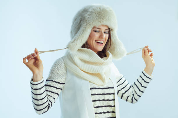 istock happy elegant female isolated on winter light blue background 1202212961