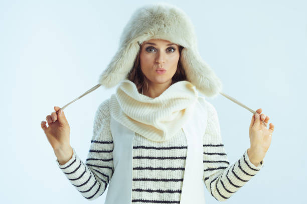 istock young female isolated on winter light blue background 1202213038