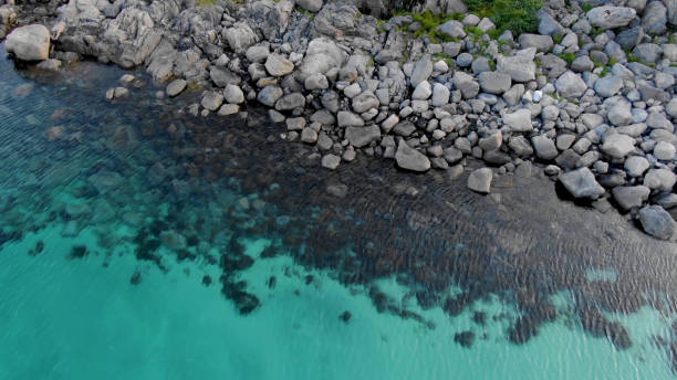 istock Turquoise water on a stone shore 1202213082