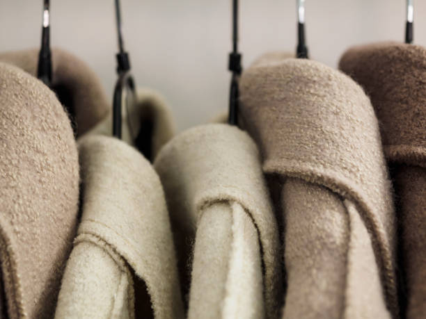 istock Several wool coats hanging on a hanger in the store 1202213296