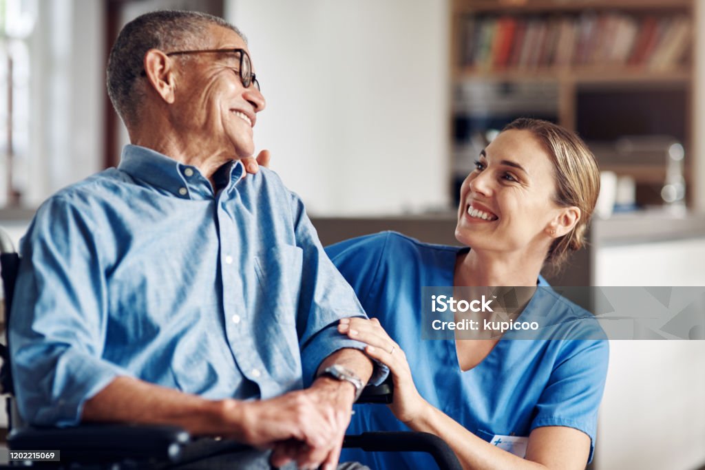 I'm so happy you're happy Shot of a senior man in a wheelchair being cared for by a nurse at home Home Caregiver Stock Photo