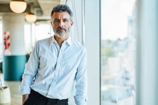 Confident mature businessman at coworking space