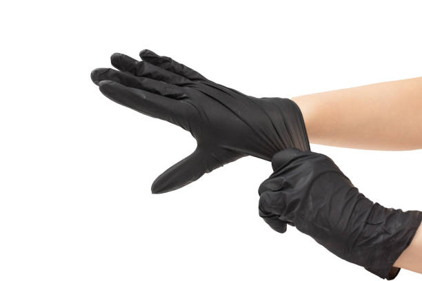 istock Woman puts on black rubber gloves. 1202216050